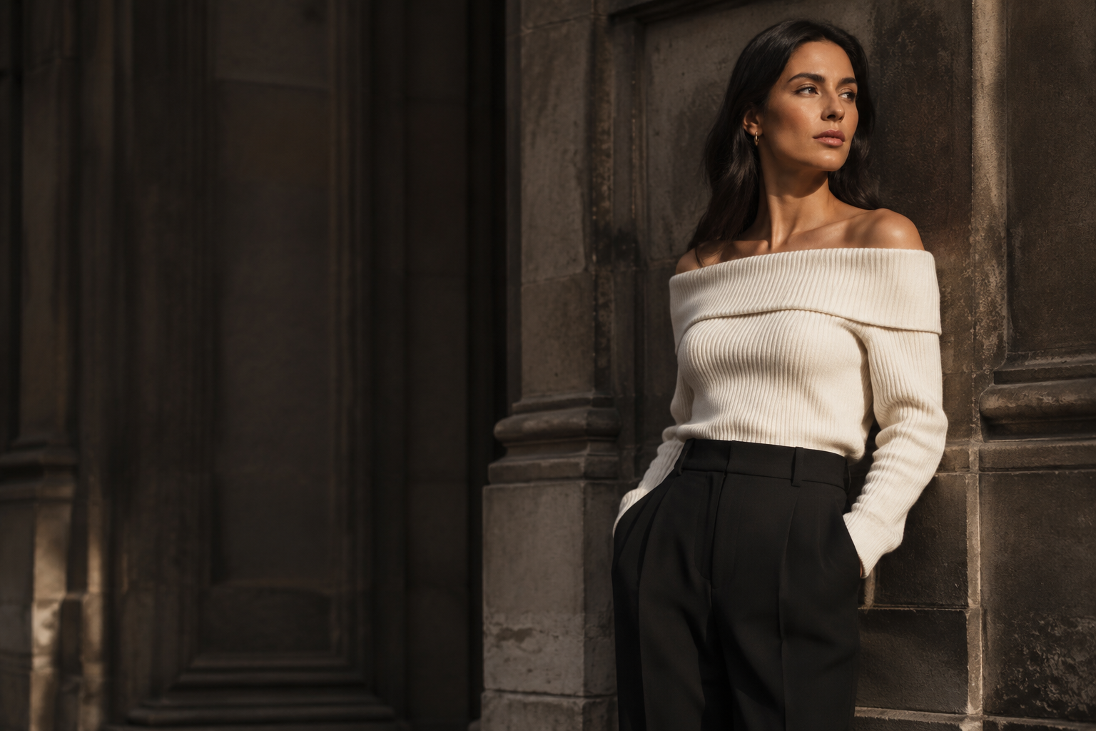Editorial winter styling concept with an ivory knit and black trousers